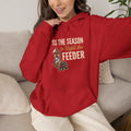 Holiday hoodie with ''Tis the Season to Refill the Feeder' chickadee and snowy bird feeder design