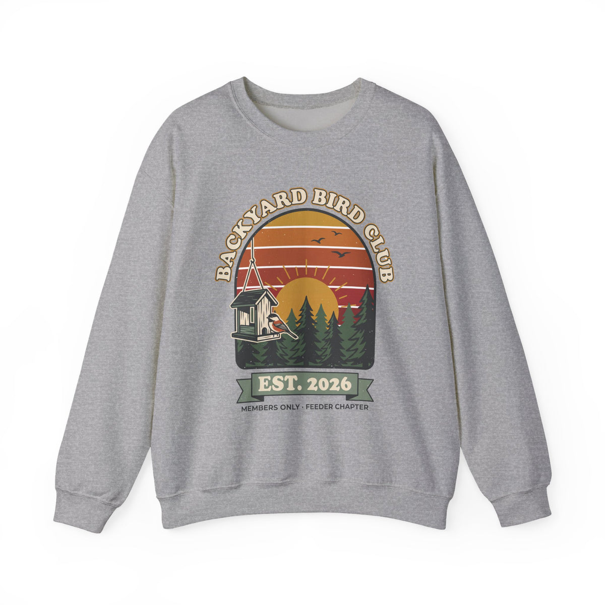 Crewneck sweatshirt with retro 'Backyard Bird Club Est. 2026' badge design featuring a sunset, pine trees and a chickadee at a bird feeder
