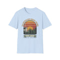 T-shirt with retro 'Backyard Bird Club Est. 2026' badge design featuring a sunset, pine trees and a chickadee at a bird feeder