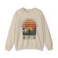 Crewneck sweatshirt with retro 'Backyard Bird Club Est. 2026' badge design featuring a sunset, pine trees and a chickadee at a bird feeder