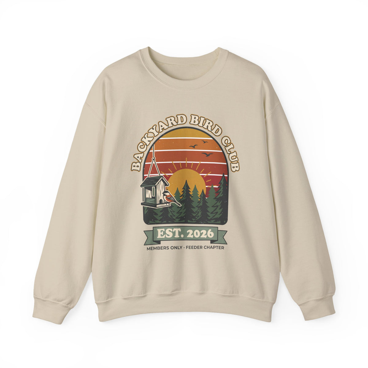 Crewneck sweatshirt with retro 'Backyard Bird Club Est. 2026' badge design featuring a sunset, pine trees and a chickadee at a bird feeder