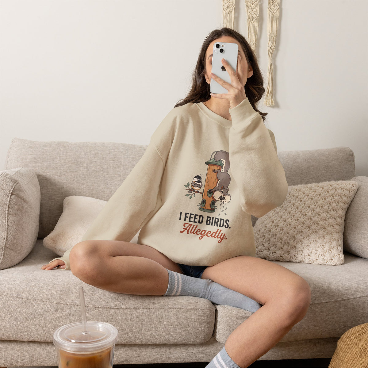 Crewneck sweatshirt with funny 'I Feed Birds. Allegedly.' design of a squirrel raiding a bird feeder