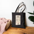 Black canvas tote bag with funny Backyard Birding Co. receipt design, 'Total: Worth it'